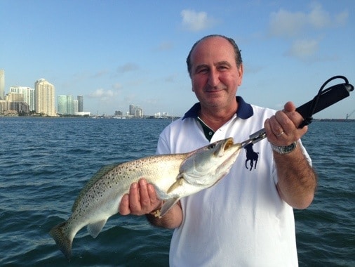 happy customer with sea trout in biscayne bay